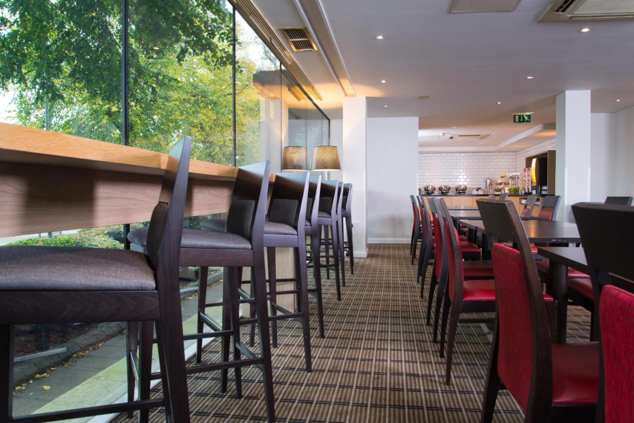 a restaurant with a row of chairs and a bar at Holiday Inn Express Bath by IHG in Bath